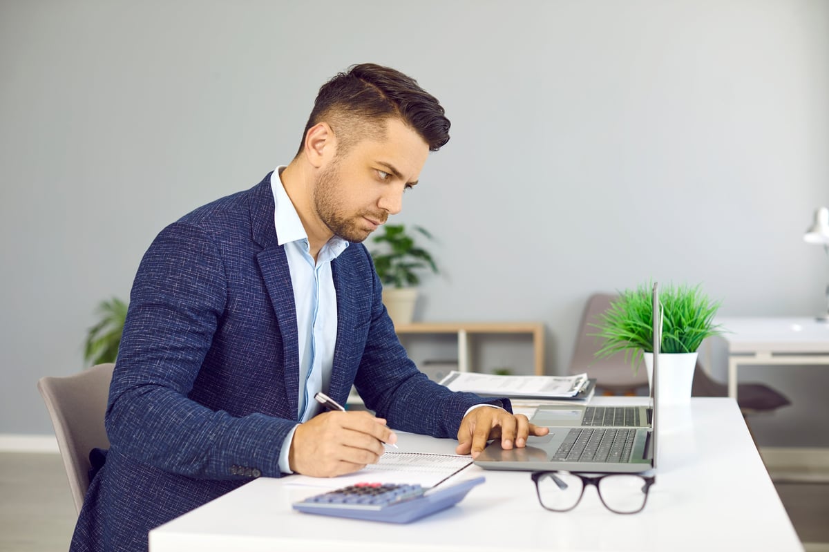 Financial director performing budget analysis and calculations at his desk
